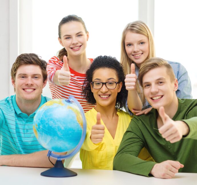 five smiling student with earth globe at school